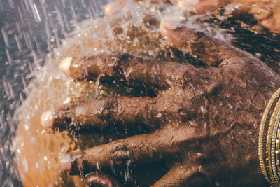 Close-up of man showering during religious ceremony