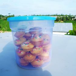 Close-up of fruits in glass container on table