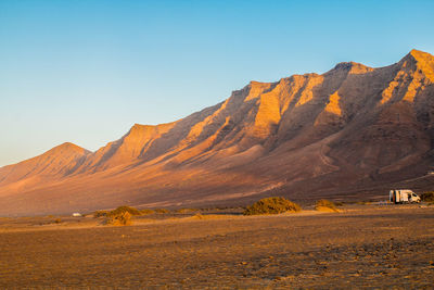 Scenic view of desert against clear sky