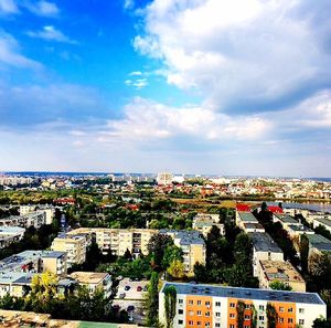 Cityscape against cloudy sky