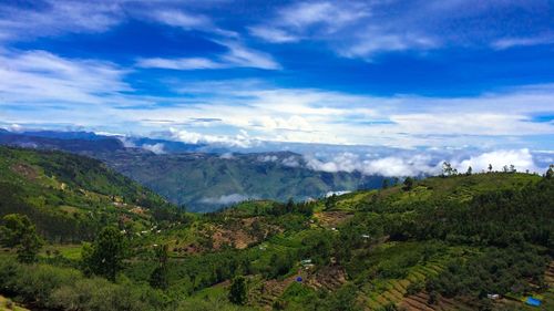 Scenic view of mountains against cloudy sky