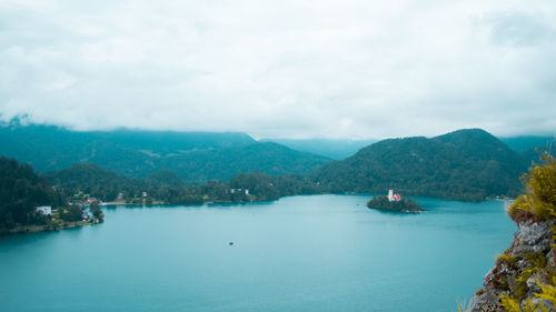 Scenic view of sea and mountains against sky