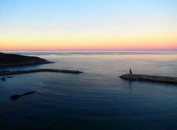 Scenic view of sea against clear sky during sunset