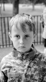 Close-up portrait of cute boy standing outdoors