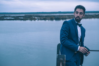 Portrait of young man standing in water