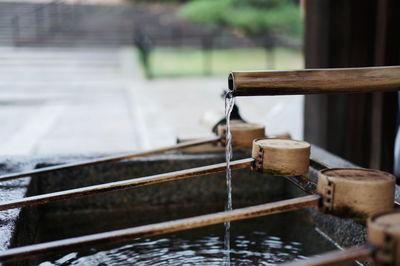 Close-up of wooden ladles by water