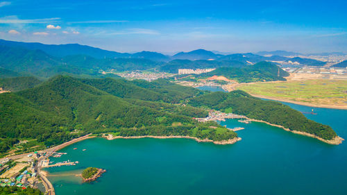 Aerial view of bay and mountains against sky