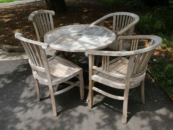 High angle view of empty chairs and tables in yard