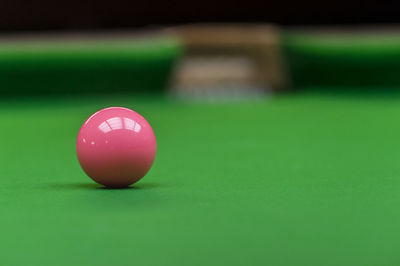 Close-up of pink ball on pool table