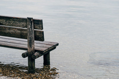 Part of wooden bench in water