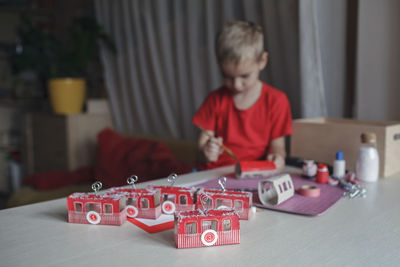 Boy playing with toy blocks at home