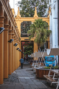 People on table by buildings in city