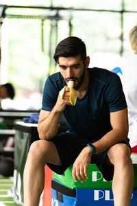 Young man sitting on seat