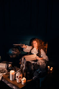 Woman sitting on table at home