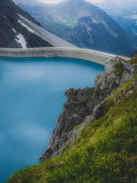 High angle view of bridge by river against mountains