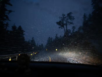 Raindrops on car windshield at night