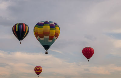 Hot air balloons flying against sky