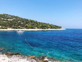 Scenic view of sea against clear blue sky