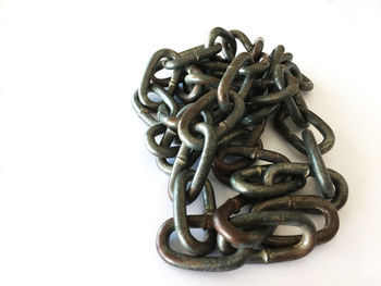 Close-up of metal chain against white background