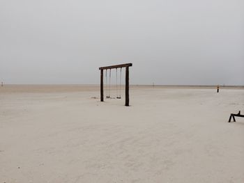 Lifeguard hut on beach against clear sky