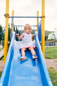 Boy playing on slide at playground