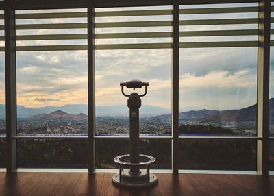 View of cityscape through window at an observation deck