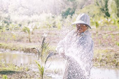 Rear view of man standing by plants