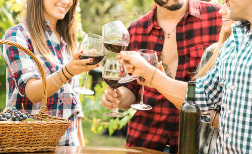 Smiling friends toasting wine