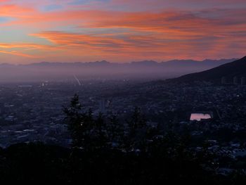 Scenic view of mountains against orange sky