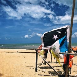 Lifeguard hut on beach against sky