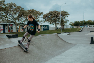 Full length of man skateboarding on skateboard against sky