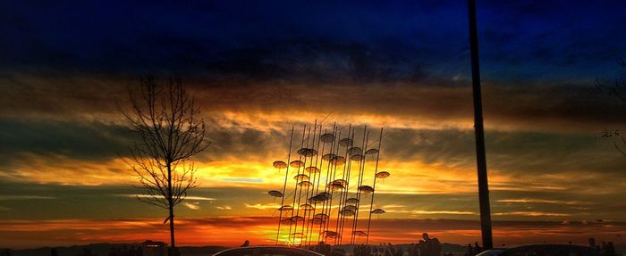 Silhouette plants against romantic sky at sunset