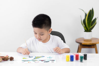 Boy looking at camera on table