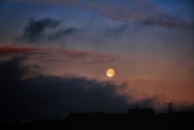 Low angle view of silhouette moon against sky during sunset