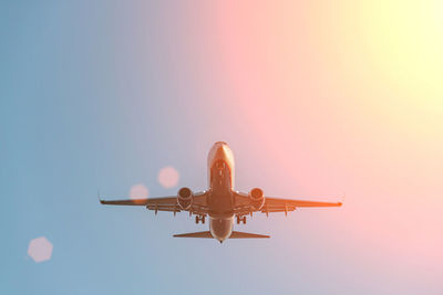 Low angle view of airplane flying against sky