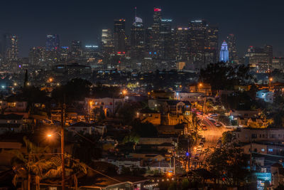 High angle view of illuminated buildings in city at night