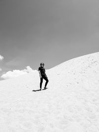 Full length of person on sand mountain against sky