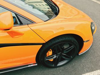 Close-up of yellow car on street