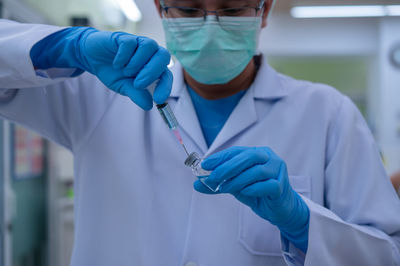 Midsection of man holding umbrella