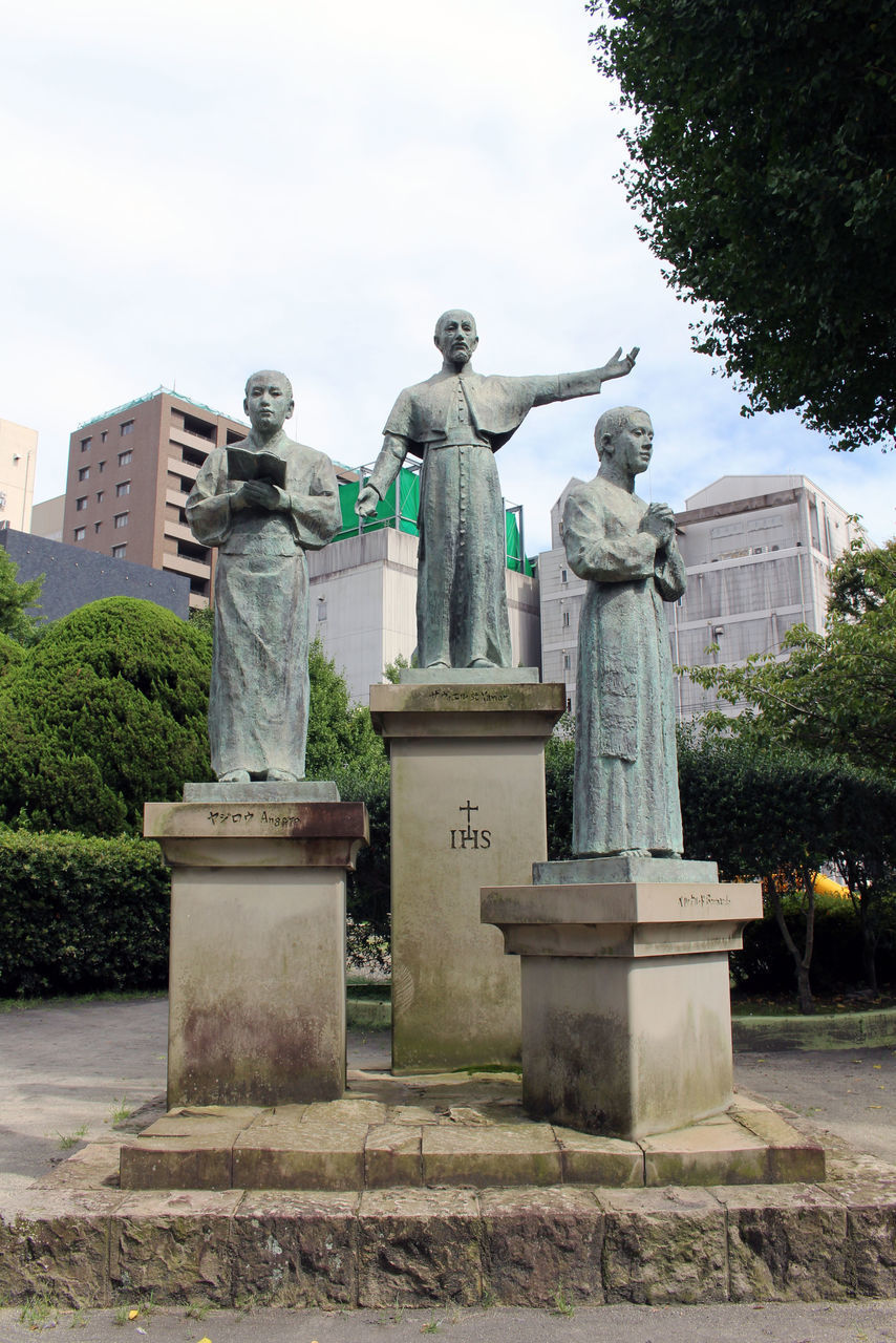 STATUE AGAINST STONE WALL