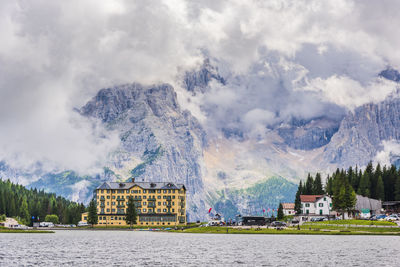 Panoramic view of lake and buildings against sky