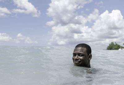 Portrait of young woman swimming in sea