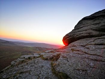 Scenic view of rock formation against sky during sunset