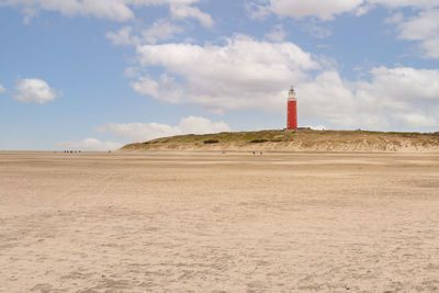 Sandy beach and lighthouse called eierland, on the wadden island of texel, the netherlands