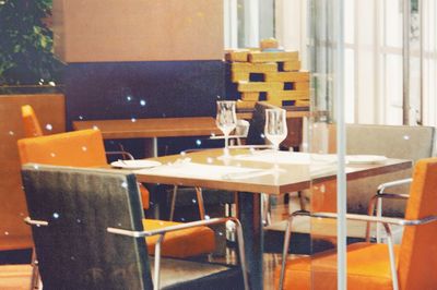 Close-up of chairs and table in restaurant
