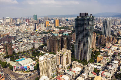 High angle view of modern buildings in city against sky