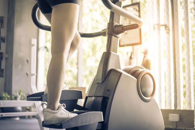 Low section of woman exercising in gym