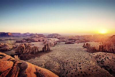 Scenic view of desert against sky during sunset