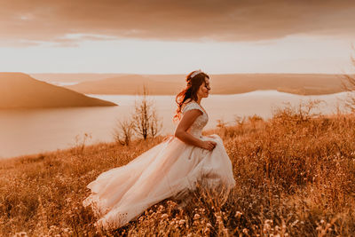 Rear view of woman standing on field