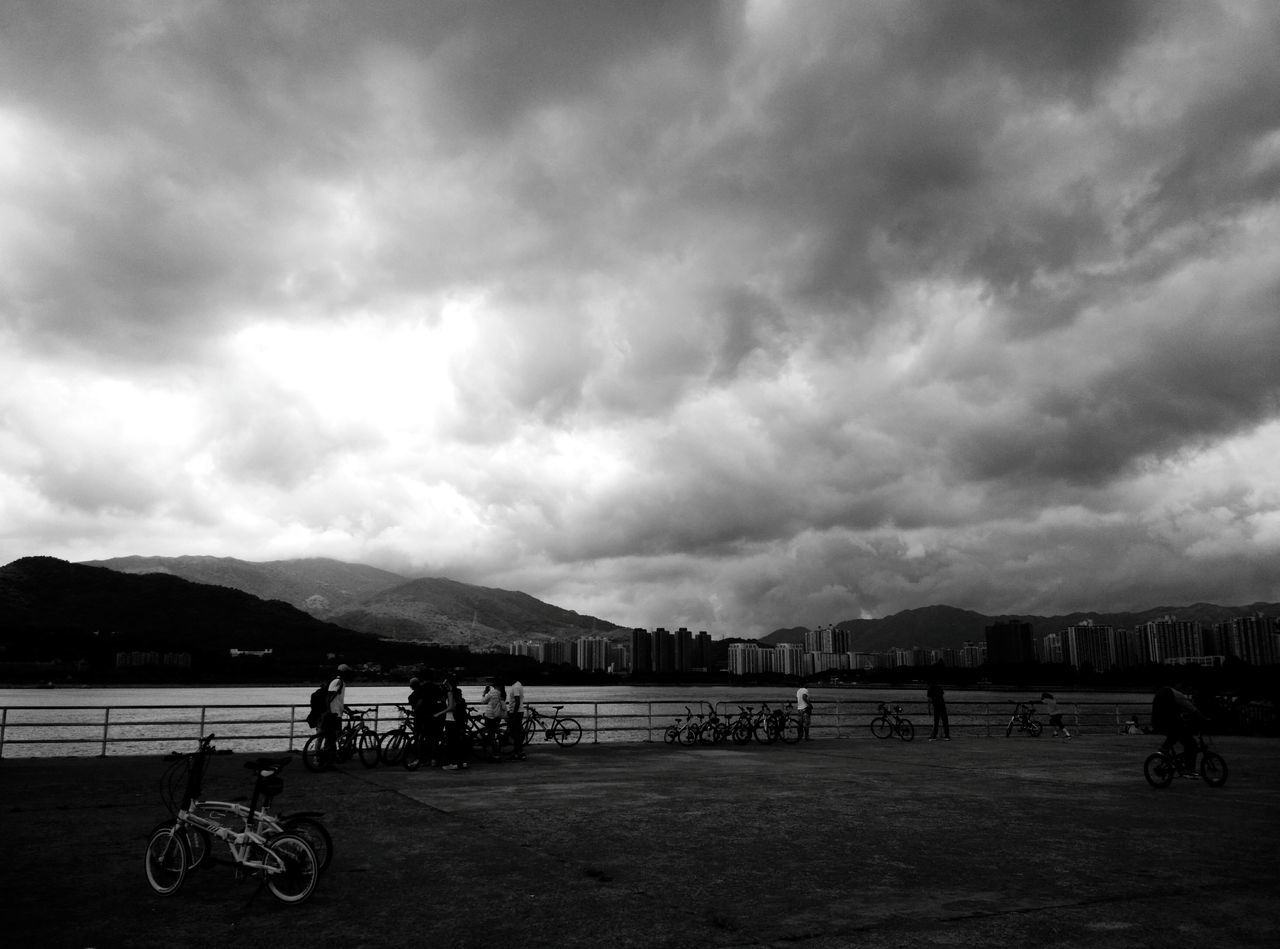 cloud - sky, sky, cloudy, mountain, water, weather, scenics, mountain range, cloud, overcast, lifestyles, leisure activity, nature, sea, tranquility, men, tranquil scene, beauty in nature, transportation